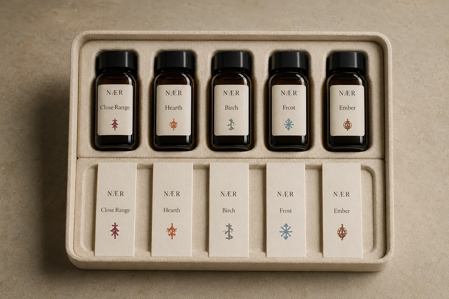 NÆR discovery kit with five fragrance oil samples labeled by scent name and branch-rune insignia